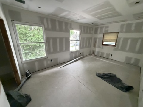 Bedroom renovation with newly installed drywall