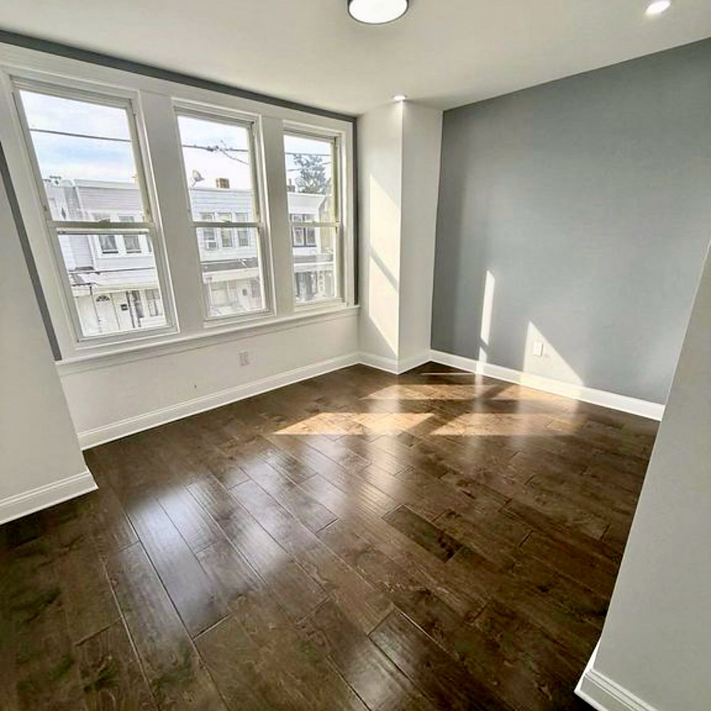 Renovated bedroom with hardwood floors